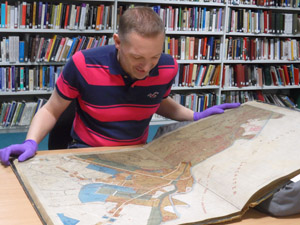 Researcher viewing map in Local Studies & Archive Centre