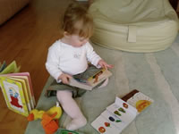 Photograph of a baby with books