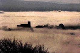 a photograph of Mottram Church in early morning mist