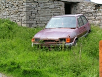 A photograph of an abandoned vehicle