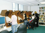 Researchers using microfim readers at Tameside Local Studies and Archives. Most church records are held on microfilm.