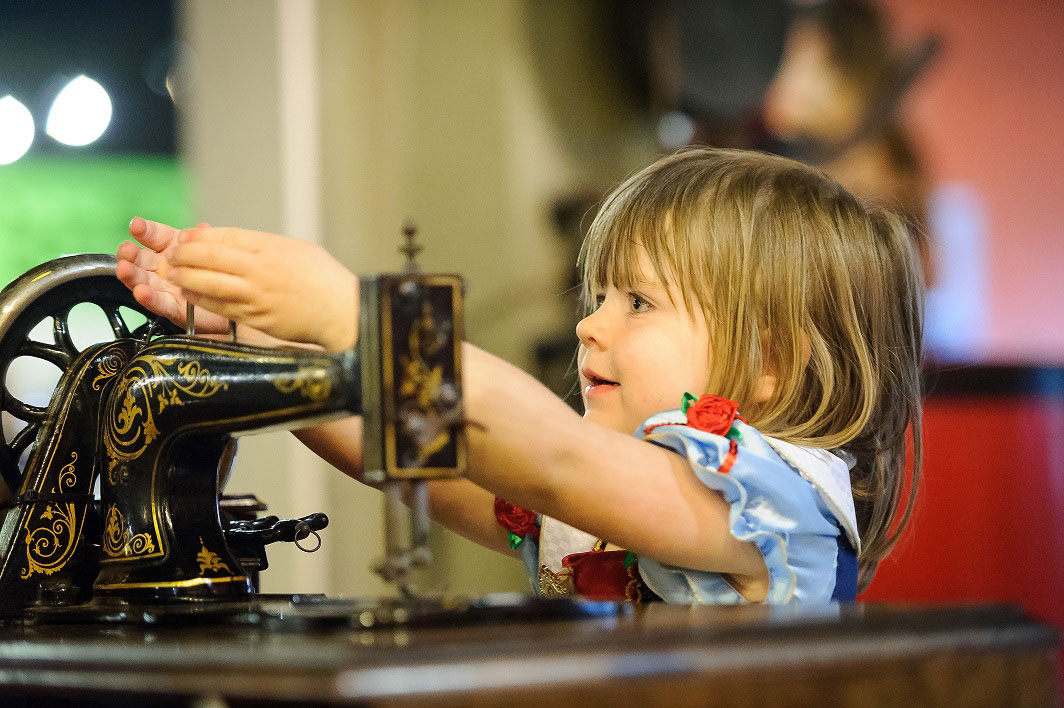Photo of a Girl with a sewing machine at Portland Basin Museum
