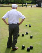 Picture of man playing bowling on a bowling green