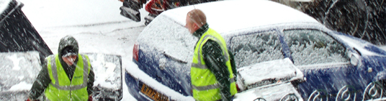 Refuse collection men working in snowy conditions