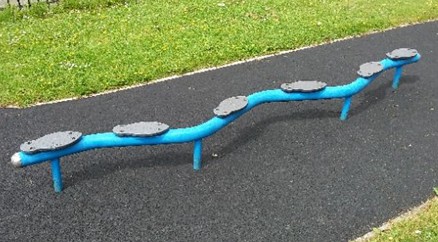 Balance beam situated on wetpour