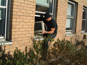 Image of a burglar stealing a computer