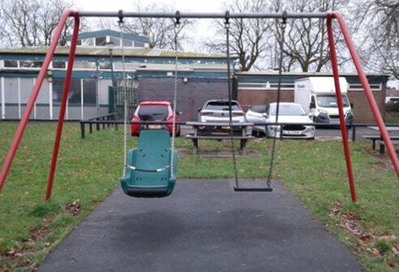 One inclusive swing with safety chain and one flat seat swing situated on wetpour