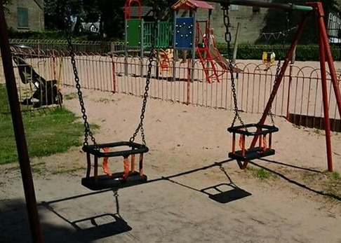 Two Cradle seat swings situated on grass matting