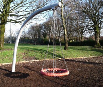 Two cradle swings situated on wetpour