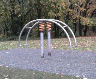 Four flat seat swings situated on wetpour
