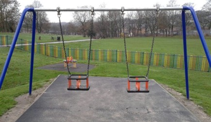 Two cradle seat swings situated on wetpour