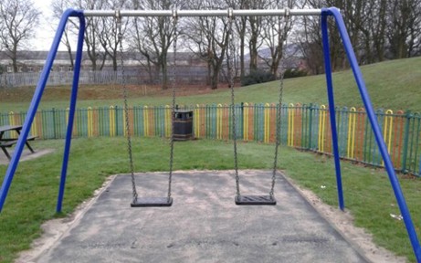 Two flat seat swings situated on wetpour