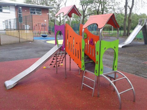 Climbing Frame with slide, step, rope ladder and ladders situated on wetpour