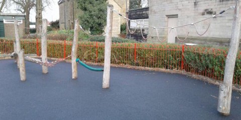 Activity Trail, wooden activity trail with ropes and wooden beems situated on wetpour