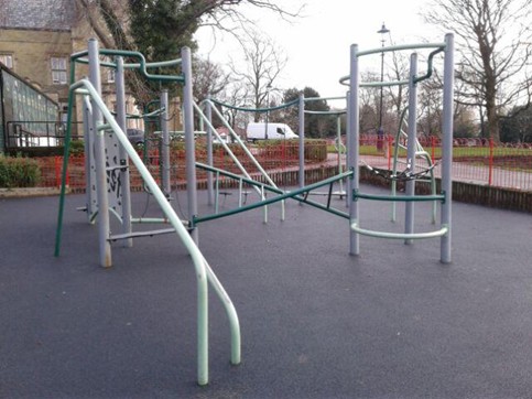 Climbing frame, metal climbing apparatus with rope netting and climbing panel situated on wetpour