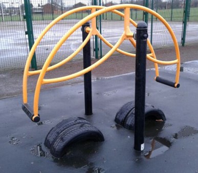 Standing seesaw situated on wetpour