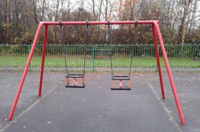 Two cradle seat swings situated on wetpour