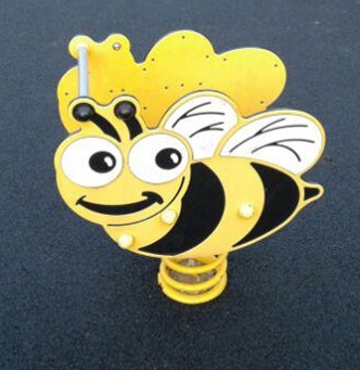 Bee spring rocker situated on wetpour