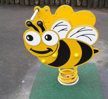 Bee spring rocker situated on wetpour