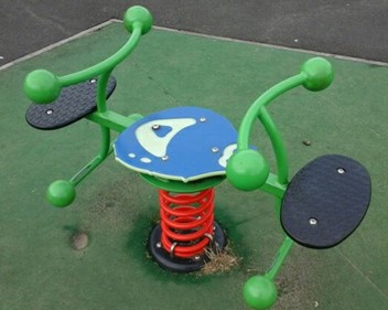 Ladybird spring rocker situated on playbark