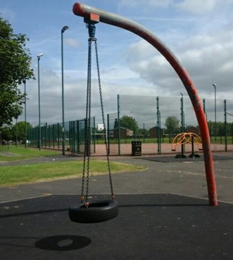 Chain tire swing situated on wetpour