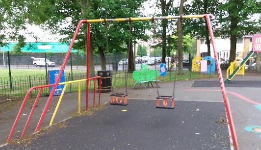 Two cradle swings situated on wetpour