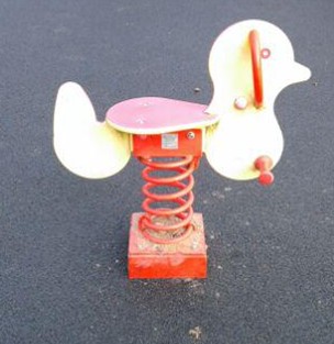Bird spring rocker situated on wetpour