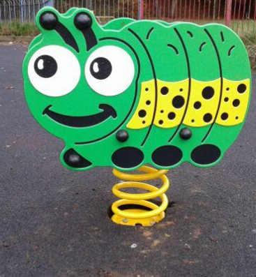 Caterpillar spring rocker situated on wetpour