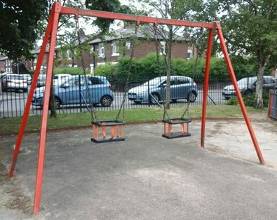 Two cradle seat swings situated on wetpour