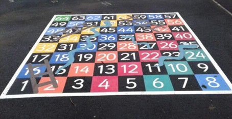 Snakes and Ladders hopscotch situated on wetpour