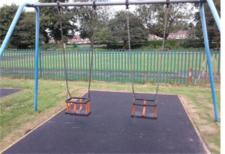 Two cradle swings situated on wetpour