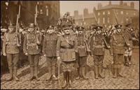 The only men of the 8th Battalion to have survived the Great War from mobilisation in 1914.  Captain Stewart is seen in the centre. Taken outside the Battalion drill hall at Ardwick Green, 1919 (MRP/4/E)