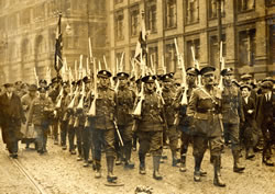 8th Bn marching along London Road, Manchester on their return from Belgium in 1919.  Captain Stewart in front. (MRP4/E)