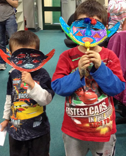 boys showing masks made at Junior History Club