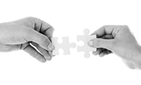 2 hands holding a jigsaw piece each