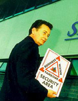 Community Safety Officer Mike Rhodes with a Business Watch Sign
