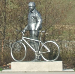 a picture of a bronze statute of a cyclist located on Lord Sheldon Way