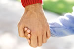 Parent holding a child's hand