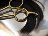 Picture of hairdressing scissors and a lock of hair